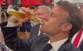 Macron (sfidato dalla squadra di rugby) beve una bottiglia di birra tutta in un sorso
